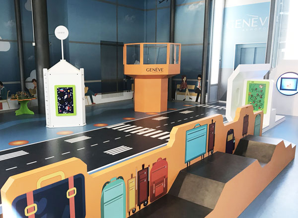 Airport-themed children’s play corner with baggage carousel and control tower