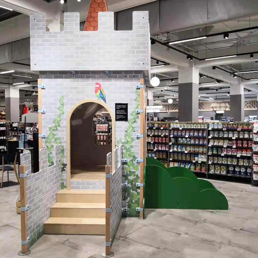Op deze afbeelding staat een custom kinderhoek in een supermarkt
