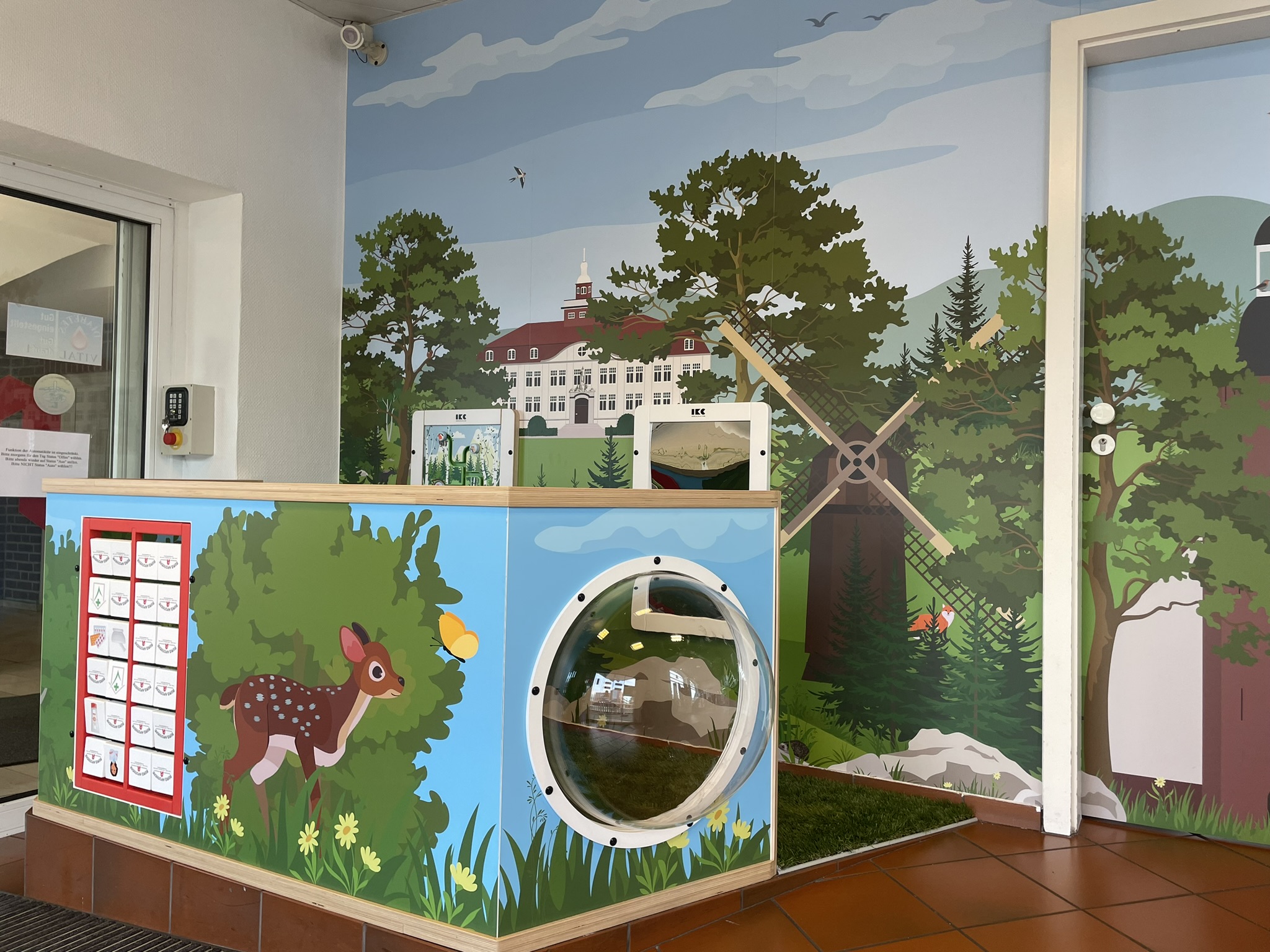Interactive children’s play corner with farm-themed design, featuring a windmill, tunnel, and animal graphics